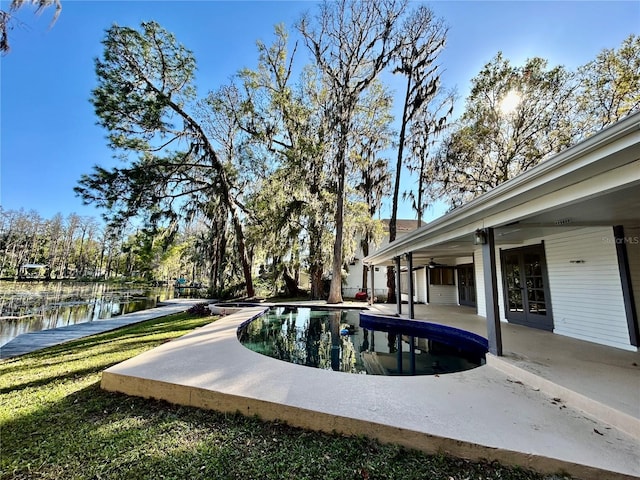 17017 Paula Ln, Lutz, FL 33558 - outdoor pool with a patio area, a ceiling fan, and a water view