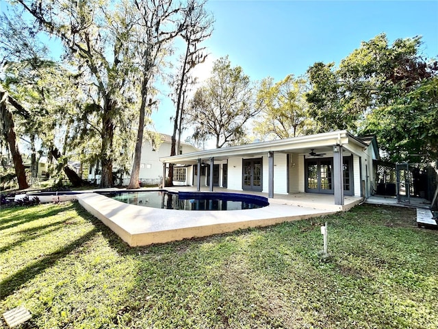 17017 Paula Ln, Lutz, FL 33558 - rear view of property with french doors, a lawn, an outdoor pool, ceiling fan, and a patio area