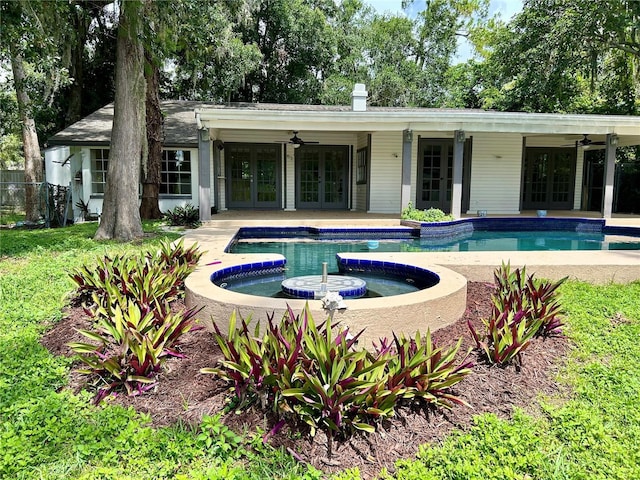 17017 Paula Ln, Lutz, FL 33558 - outdoor pool with french doors, a ceiling fan, and a patio area