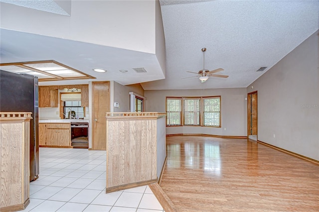 11070 Tilburg St, Spring Hill, FL 34608 - kitchen featuring fridge, black dishwasher, a ceiling fan, light countertops, and a textured ceiling