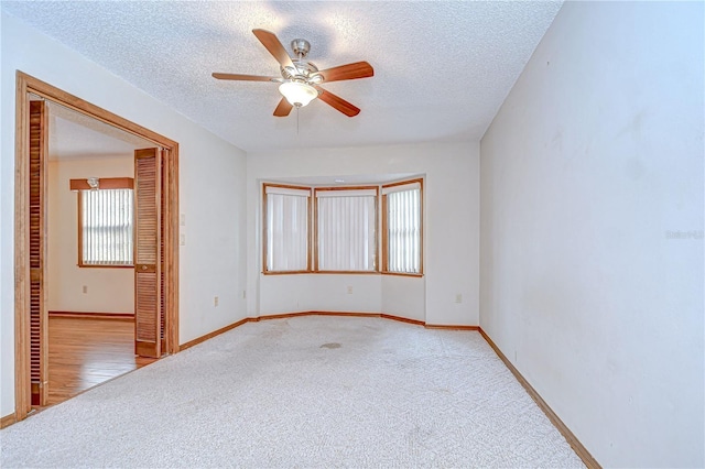11070 Tilburg St, Spring Hill, FL 34608 - empty room featuring light colored carpet, a ceiling fan, and a textured ceiling