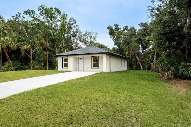 18146 Sinatra Ave, Port Charlotte, FL 33954 - view of front of property with driveway, a front lawn, and stucco siding