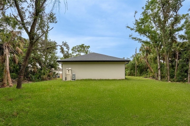 18146 Sinatra Ave, Port Charlotte, FL 33954 - view of side of property with a yard and stucco siding