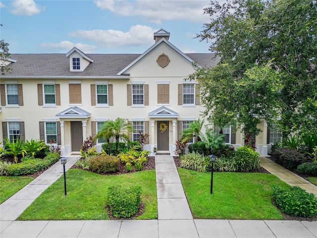 5642 Simonton St, Bradenton, FL 34203 - townhome / multi-family property featuring stucco siding, a front lawn, and a shingled roof