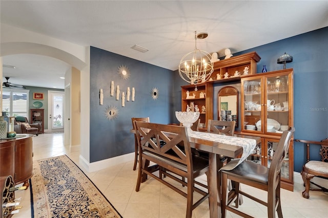 5642 Simonton St, Bradenton, FL 34203 - dining area with arched walkways, a chandelier, and light tile patterned flooring