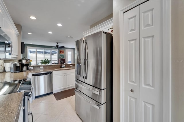 5642 Simonton St, Bradenton, FL 34203 - kitchen with stainless steel appliances, white cabinets, ceiling fan, recessed lighting, and light tile patterned floors