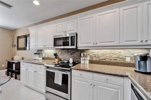 5642 Simonton St, Bradenton, FL 34203 - kitchen featuring appliances with stainless steel finishes, decorative backsplash, white cabinets, and recessed lighting