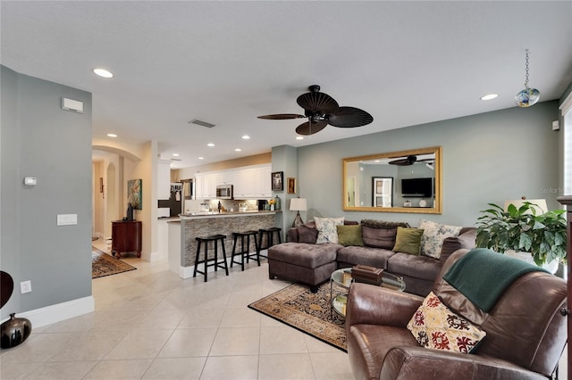 5642 Simonton St, Bradenton, FL 34203 - living room with arched walkways, a ceiling fan, light tile patterned flooring, and recessed lighting