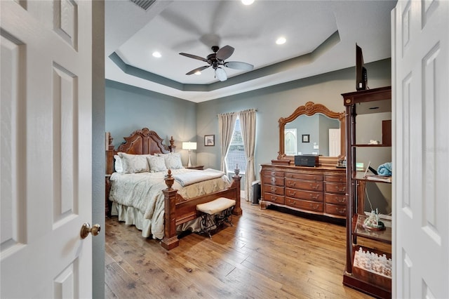 5642 Simonton St, Bradenton, FL 34203 - bedroom with a tray ceiling, wood-type flooring, recessed lighting, and a ceiling fan