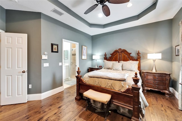 5642 Simonton St, Bradenton, FL 34203 - bedroom with hardwood / wood-style floors, a raised ceiling, recessed lighting, connected bathroom, and a ceiling fan