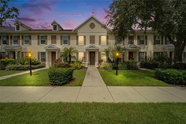 5642 Simonton St, Bradenton, FL 34203 - view of property with a lawn and stucco siding