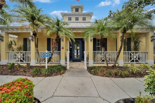 5642 Simonton St, Bradenton, FL 34203 - view of front of property with a porch, stucco siding, a standing seam roof, and a metal roof