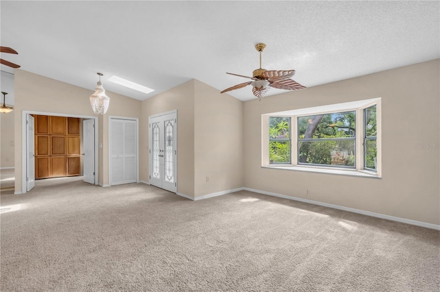 8470 Cranes Roost Dr, New Port Richey, FL 34654 - spare room with ceiling fan, light colored carpet, vaulted ceiling, and a skylight