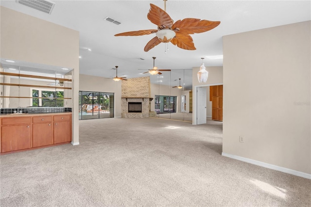 8470 Cranes Roost Dr, New Port Richey, FL 34654 - unfurnished living room with light colored carpet, ceiling fan, a fireplace, and vaulted ceiling