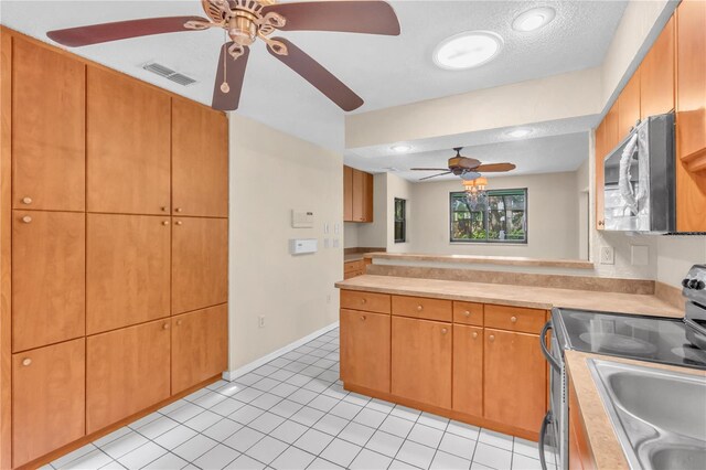 8470 Cranes Roost Dr, New Port Richey, FL 34654 - kitchen with electric range oven, stainless steel microwave, ceiling fan, light countertops, and a peninsula