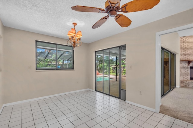 8470 Cranes Roost Dr, New Port Richey, FL 34654 - empty room with plenty of natural light, a chandelier, light tile patterned floors, ceiling fan, and a textured ceiling