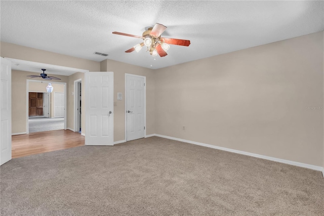 8470 Cranes Roost Dr, New Port Richey, FL 34654 - carpeted spare room with a ceiling fan and a textured ceiling