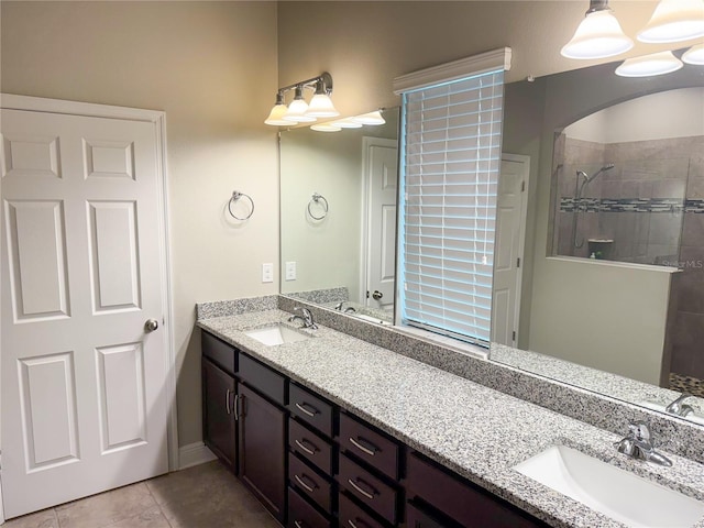 7508 Sea Lilly Ct, Apollo Beach, FL 33572 - bathroom with double vanity, a tile shower, and tile patterned floors