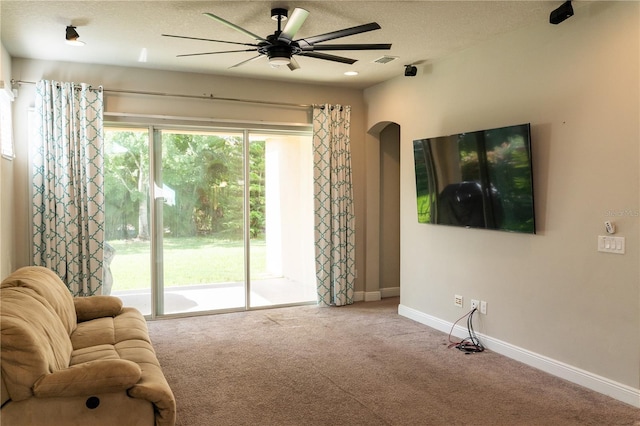 7508 Sea Lilly Ct, Apollo Beach, FL 33572 - living area with a ceiling fan, carpet floors, a textured ceiling, and arched walkways