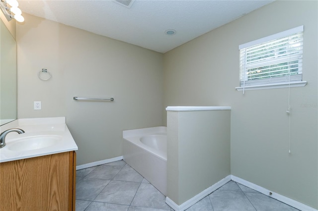 13190 Drysdale St, Spring Hill, FL 34609 - full bathroom with vanity, a garden tub, tile patterned floors, and a textured ceiling