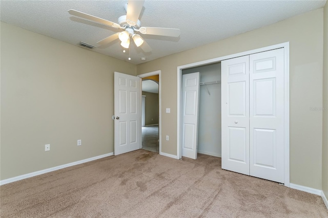 13190 Drysdale St, Spring Hill, FL 34609 - unfurnished bedroom featuring carpet, a closet, a ceiling fan, and a textured ceiling