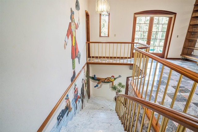 7715 Riverview Dr, Riverview, FL 33578 - stairs featuring arched walkways, french doors, and a chandelier