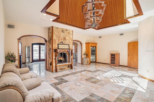 7715 Riverview Dr, Riverview, FL 33578 - living area with arched walkways, recessed lighting, inlaid floor details, and a fireplace