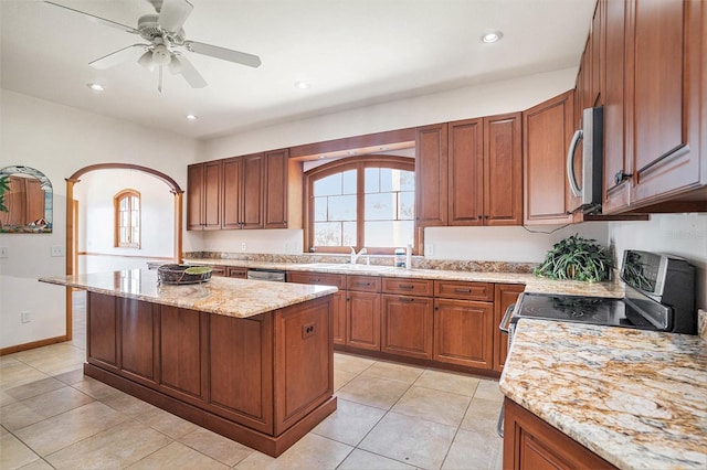 7715 Riverview Dr, Riverview, FL 33578 - kitchen with appliances with stainless steel finishes, healthy amount of natural light, light stone counters, a center island, and recessed lighting