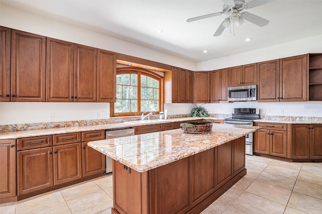 7715 Riverview Dr, Riverview, FL 33578 - kitchen featuring appliances with stainless steel finishes, open shelves, light tile patterned flooring, a center island, and light stone countertops