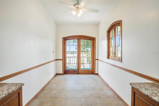 7715 Riverview Dr, Riverview, FL 33578 - doorway to outside with french doors, a ceiling fan, arched walkways, and light tile patterned floors