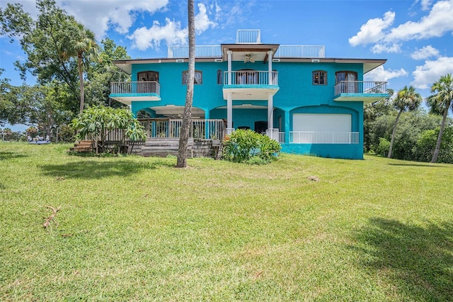 7715 Riverview Dr, Riverview, FL 33578 - rear view of property with a balcony and a yard