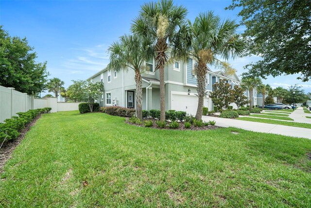 2101 Sunset Wind Loop, Oldsmar, FL 34677 - view of side of property with stucco siding, driveway, and an attached garage