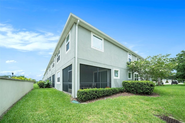 2101 Sunset Wind Loop, Oldsmar, FL 34677 - back of house with stucco siding and a yard