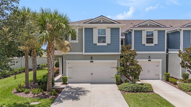 2101 Sunset Wind Loop, Oldsmar, FL 34677 - view of front of house featuring a garage, stucco siding, and concrete driveway