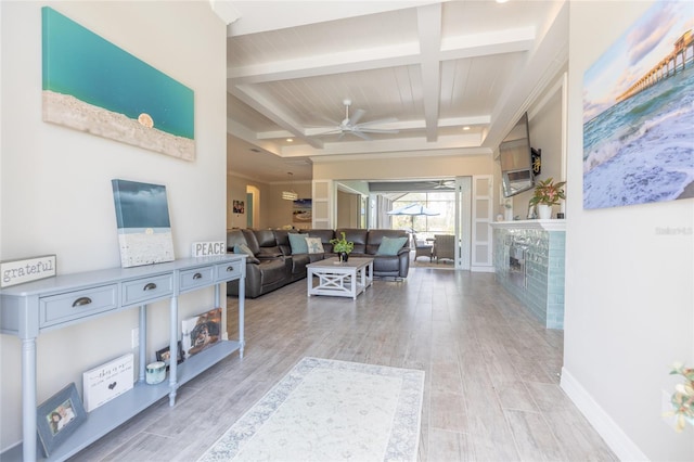 9016 Falcon Ct, Venice, FL 34293 - living area with coffered ceiling, a ceiling fan, beamed ceiling, a brick fireplace, and light wood finished floors
