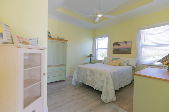 9016 Falcon Ct, Venice, FL 34293 - bedroom featuring wood finished floors, a ceiling fan, crown molding, and a tray ceiling