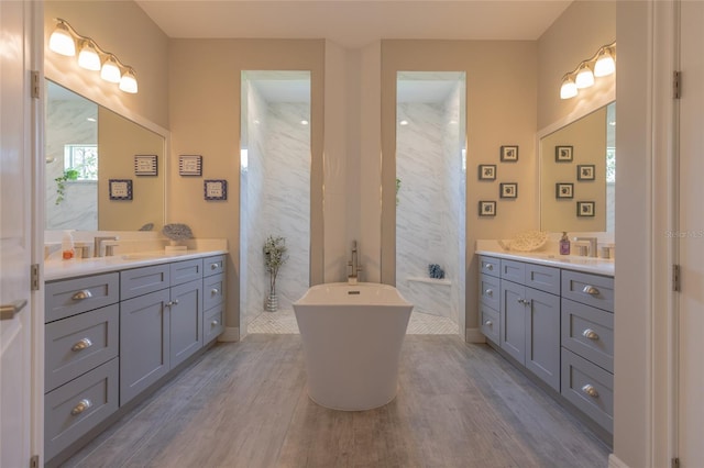 9016 Falcon Ct, Venice, FL 34293 - full bathroom with two vanities, wood finished floors, and a freestanding bath