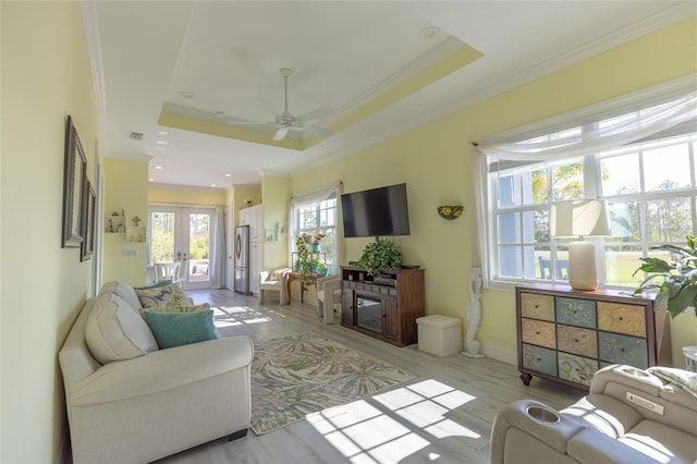 9016 Falcon Ct, Venice, FL 34293 - living area featuring french doors, crown molding, a raised ceiling, ceiling fan, and light wood finished floors