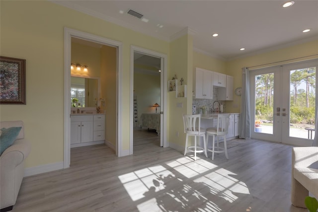 9016 Falcon Ct, Venice, FL 34293 - dining area with french doors, ornamental molding, light wood-type flooring, and recessed lighting