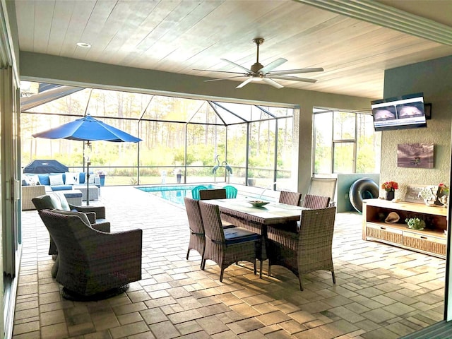 9016 Falcon Ct, Venice, FL 34293 - view of patio featuring glass enclosure, an outdoor pool, a ceiling fan, and outdoor dining space