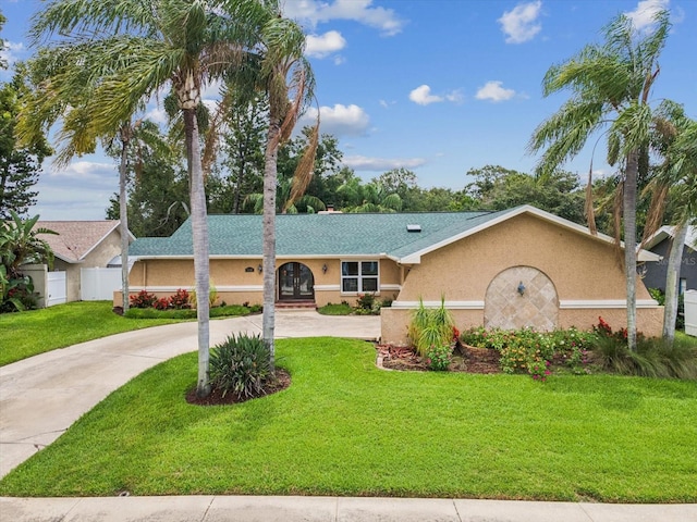 5110 Lake Valencia Blvd E, Palm Harbor, FL 34684 - ranch-style home featuring stucco siding, curved driveway, and roof with shingles