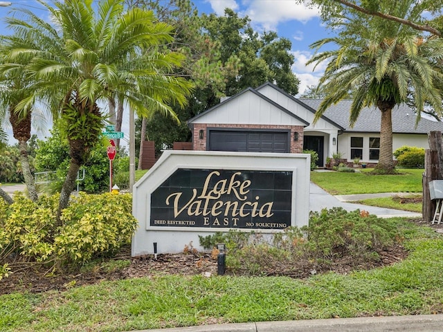 5110 Lake Valencia Blvd E, Palm Harbor, FL 34684 - community sign with an attached garage and a yard