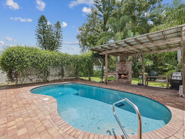 5110 Lake Valencia Blvd E, Palm Harbor, FL 34684 - view of swimming pool with an outdoor stone fireplace, a patio, and grilling area