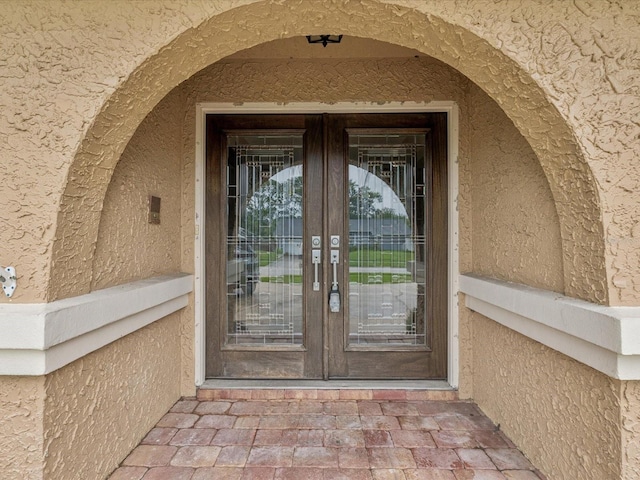 5110 Lake Valencia Blvd E, Palm Harbor, FL 34684 - entrance to property featuring french doors and stucco siding