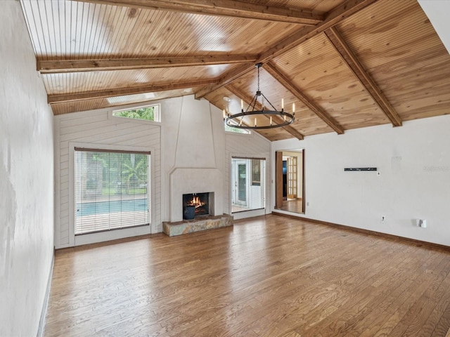 5110 Lake Valencia Blvd E, Palm Harbor, FL 34684 - unfurnished living room featuring wood finished floors, a wooden ceiling with exposed beams, a high end fireplace, high vaulted ceiling, and a chandelier