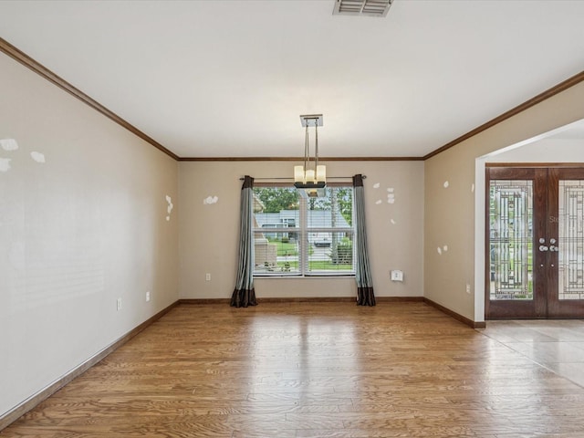 5110 Lake Valencia Blvd E, Palm Harbor, FL 34684 - unfurnished room featuring a chandelier, crown molding, wood finished floors, and french doors