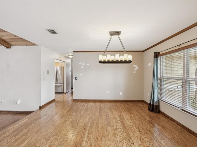5110 Lake Valencia Blvd E, Palm Harbor, FL 34684 - unfurnished room with a chandelier, light wood-type flooring, and ornamental molding