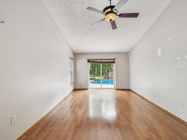 5110 Lake Valencia Blvd E, Palm Harbor, FL 34684 - empty room featuring a textured ceiling, light wood-type flooring, and a ceiling fan