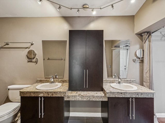 5110 Lake Valencia Blvd E, Palm Harbor, FL 34684 - full bath featuring double vanity, tile patterned floors, and track lighting