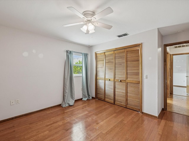 5110 Lake Valencia Blvd E, Palm Harbor, FL 34684 - unfurnished bedroom with light wood-style flooring, a closet, and a ceiling fan